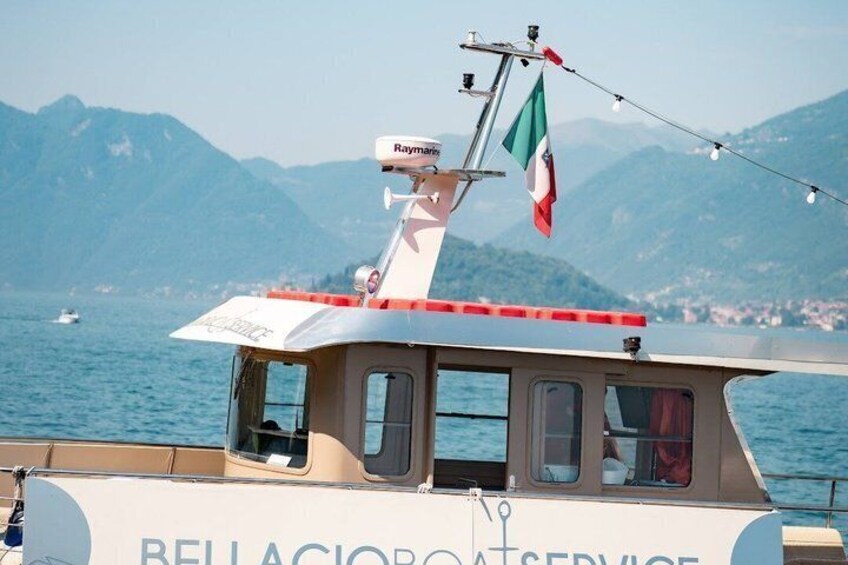A boat with a cabin, a mast, and a flag. 4