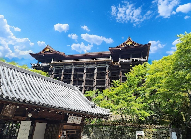 A traditional Japanese building with a tiled roof and wooden structure, surrounded by lush greenery. 2