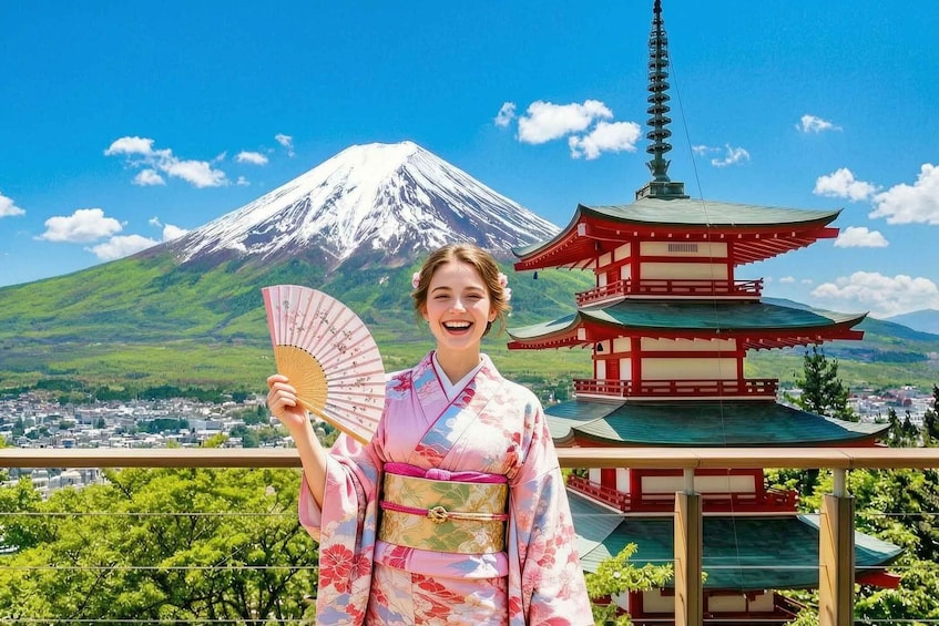 A person in a kimono holding a fan, with Mount Fuji and a traditional Japanese pagoda in the background. 1