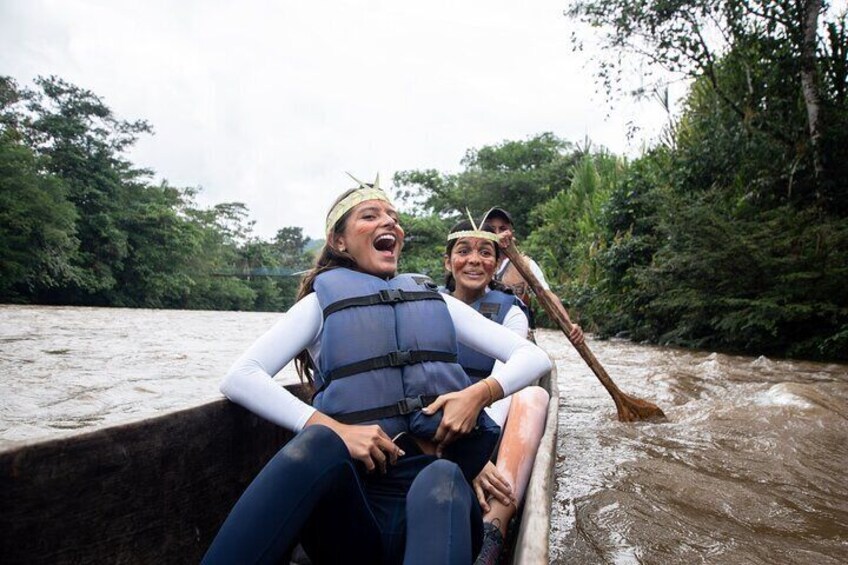 Two people in a boat on a river surrounded by greenery. 2