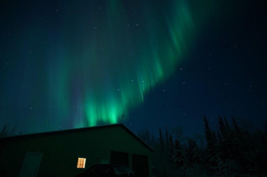 The Northern Lights over a building at night. 3