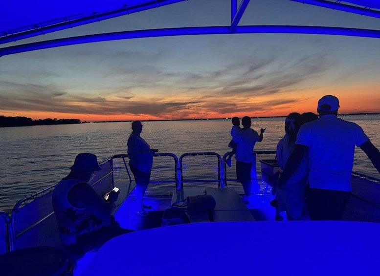 A boat at sunset with people on deck. 3