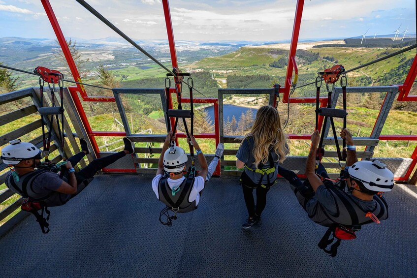 People on a cable car with a scenic view of the countryside and wind turbines. 1