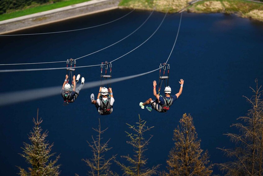 A group of people bungee jumping from a bridge over a body of water. 5