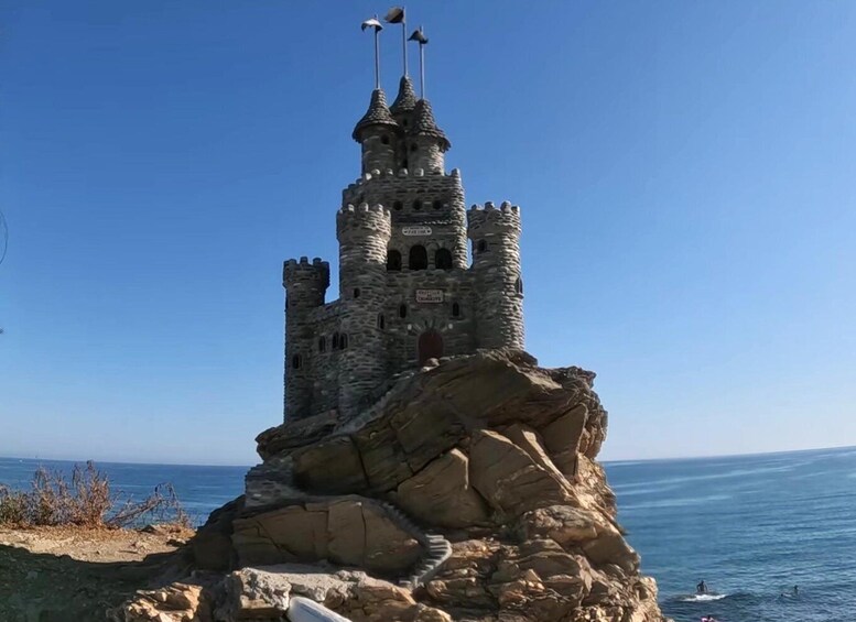 A castle-like structure on a rocky outcrop by the sea. 5
