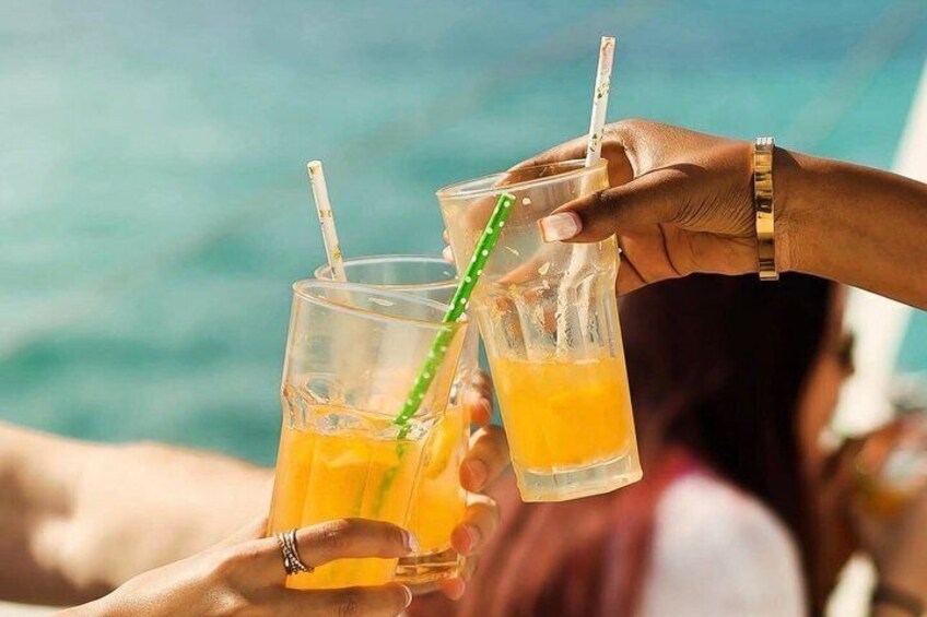 Two people holding glasses of orange juice with straws. 5