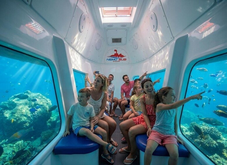 An underwater aquarium ride with people observing marine life. 3