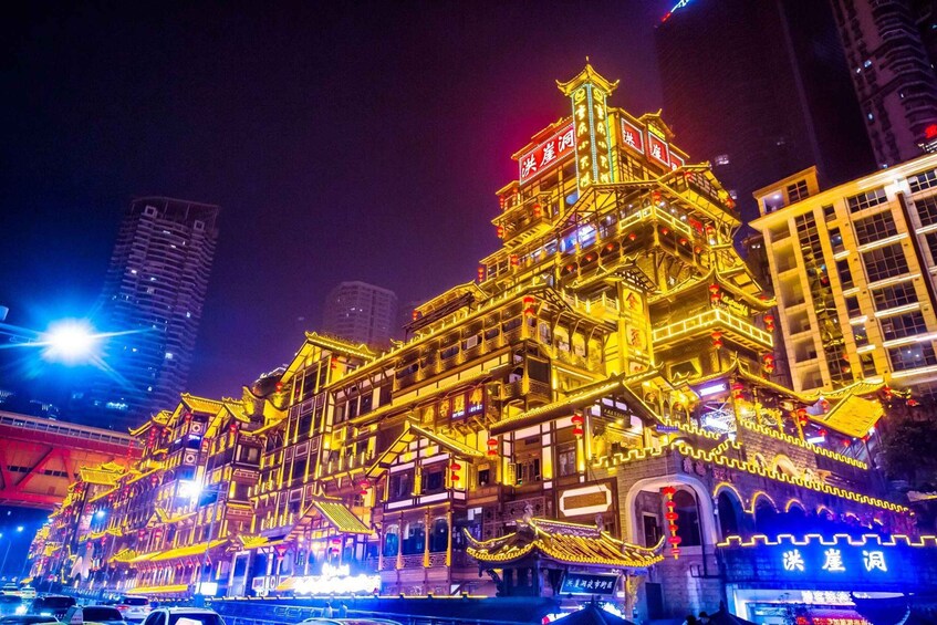 A brightly lit traditional building with ornate architecture and illuminated signage. 4