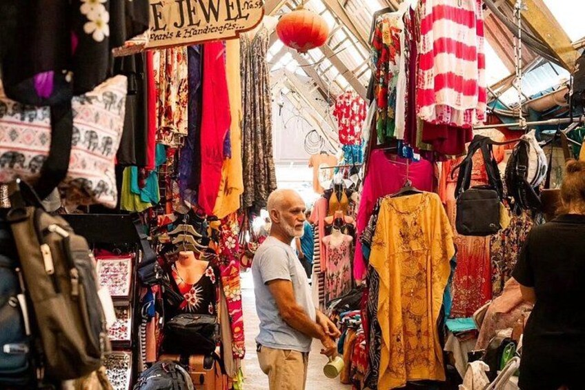 A market with colorful textiles and jewelry stalls. 1