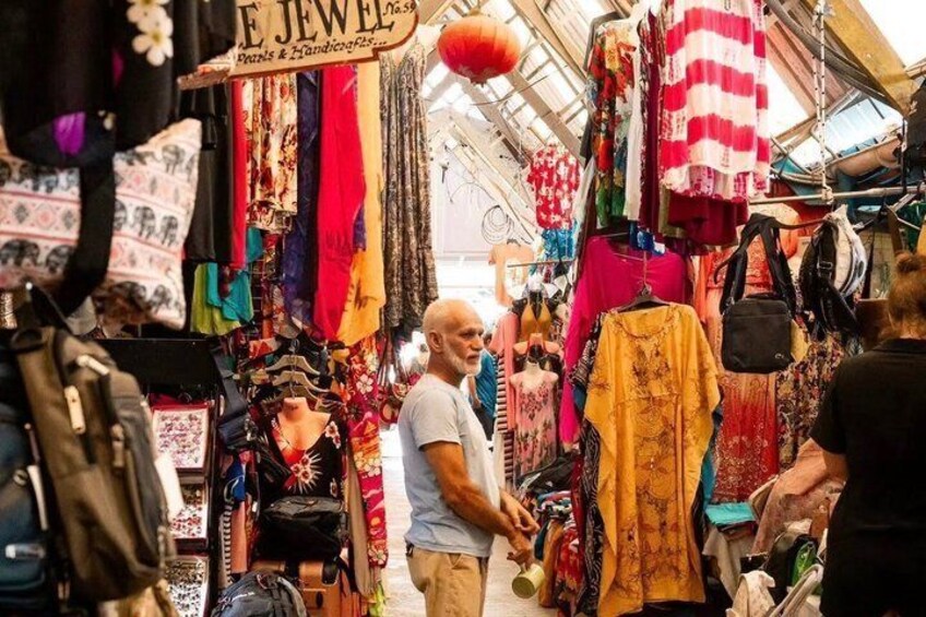 A market with colorful textiles and jewelry stalls. 1