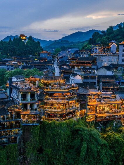 A traditional village with tiered buildings and a prominent pagoda. 4