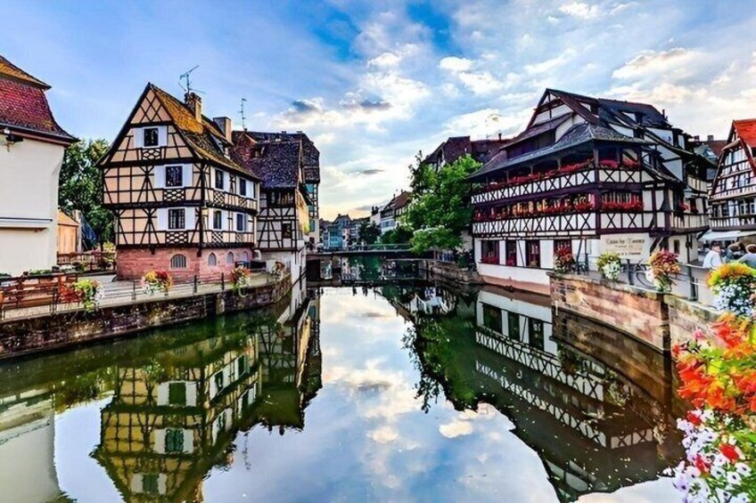 A canal with traditional half-timbered houses reflecting on the water. 1