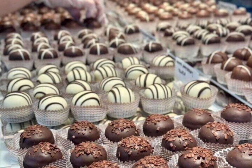 A variety of chocolate truffles in paper cups. 5