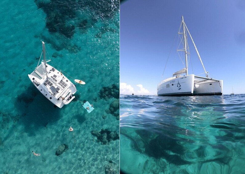 A white sailboat with a cabin and a mast, floating on clear turquoise water. 2