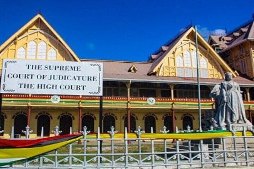 A historic building labeled 'The Supreme Court of Judicature The High Court' with a statue in front. 3