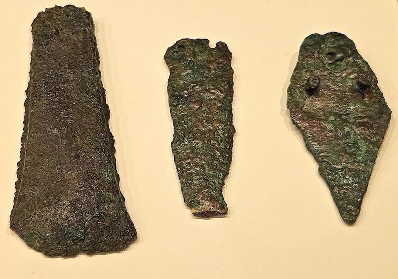 Three ancient, weathered artifacts with inscriptions, possibly of historical significance. 2