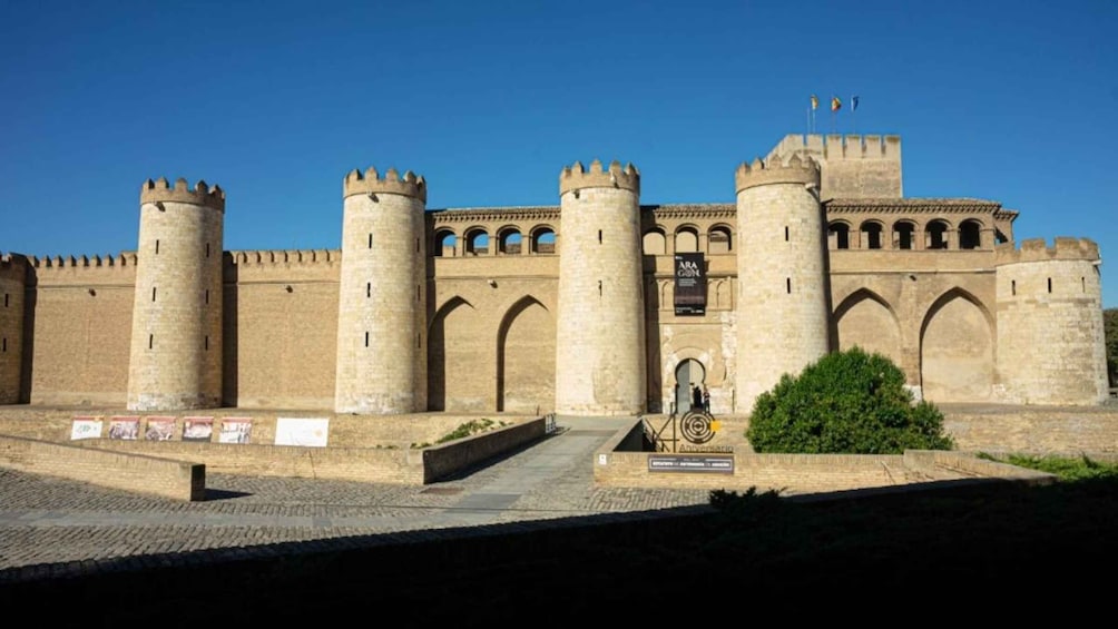 A historic castle with multiple towers and arched windows. 1