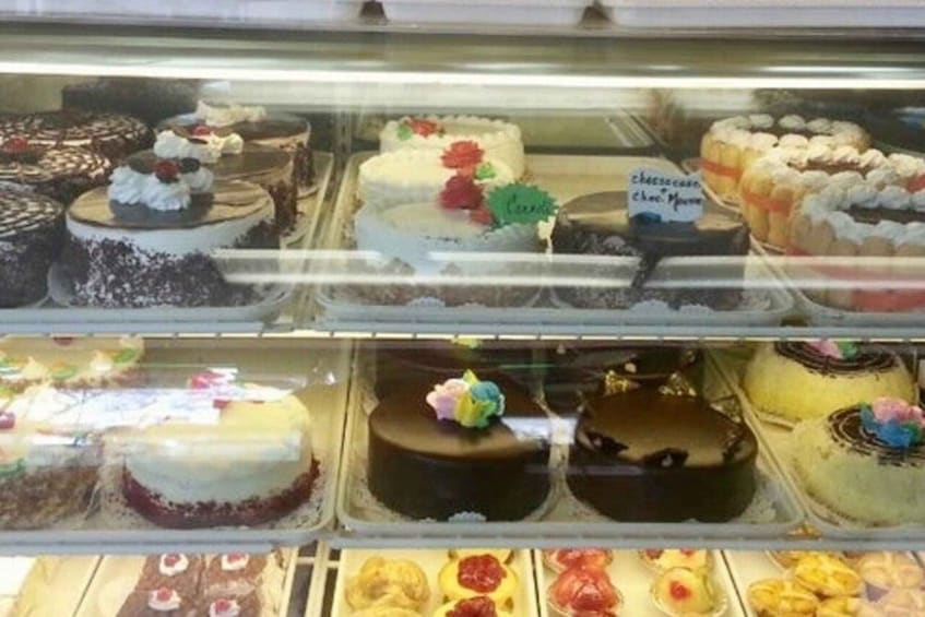 A bakery display case with various cakes and pastries. 5