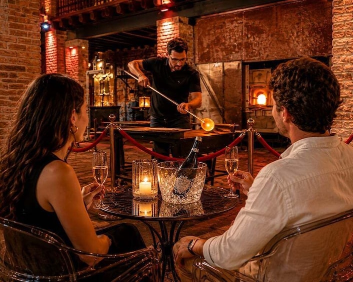 A person pouring a drink into a glass at a bar with brick walls and a warm ambiance. 1