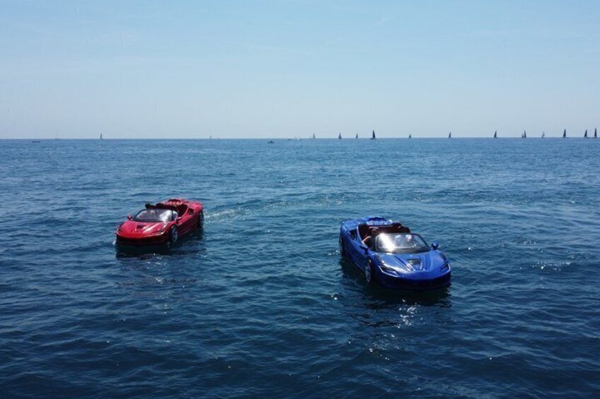 Two sports cars on a calm sea with a clear sky. 3
