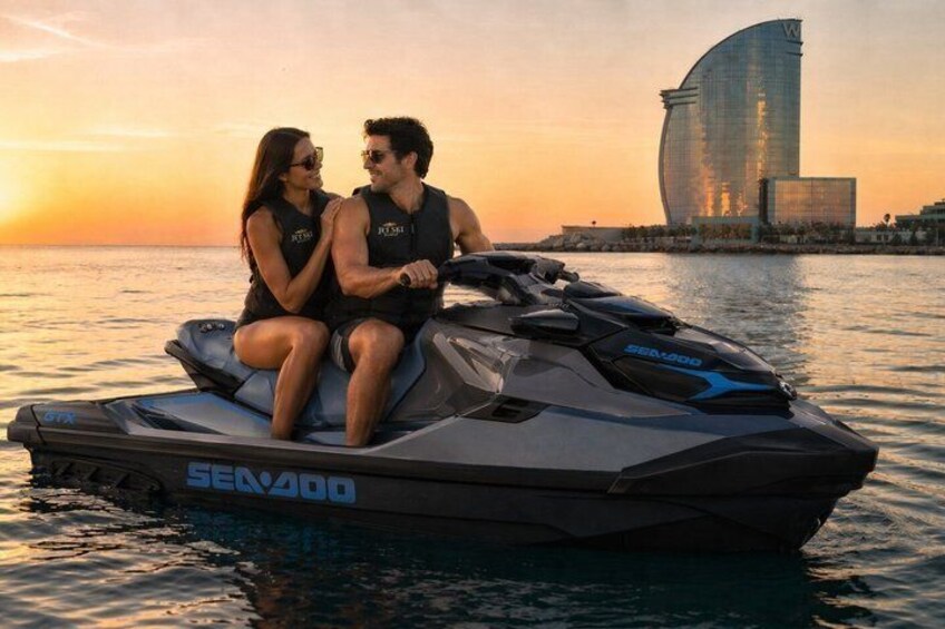 A jet ski with two people on it, a sunset, and a distinctive building in the background. 1