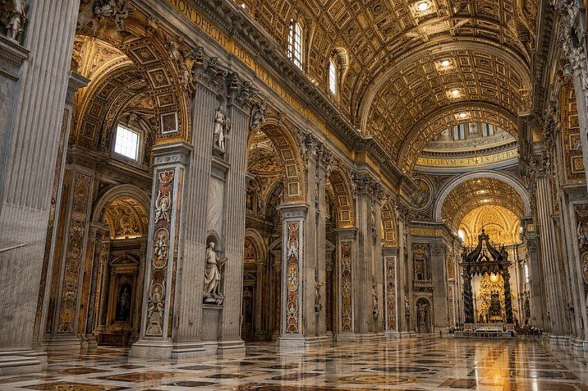 An ornate interior with high ceilings, columns, and detailed artwork. 3