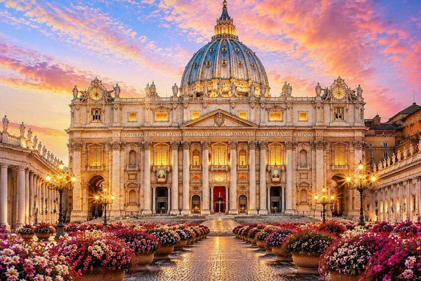 A grand building with a large dome and columns, surrounded by flower beds. 1