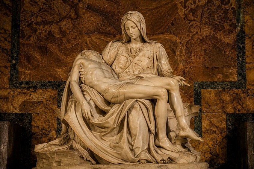A marble sculpture of a reclining woman holding a man. 5
