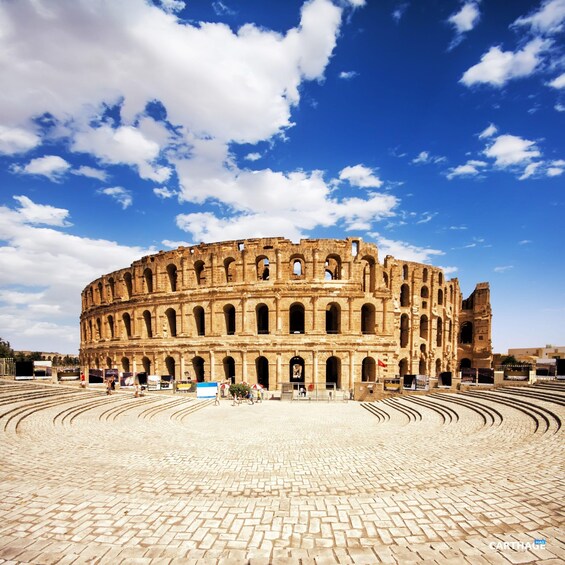 The Colosseum in Rome with clear blue sky and clouds. 2
