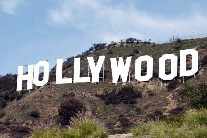 The Hollywood sign on a hill with sparse vegetation. 1