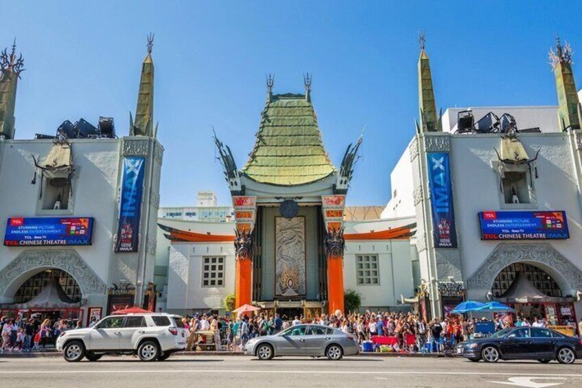 A traditional Chinese theatre with a green roof and ornate decorations. 4