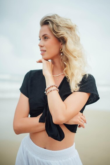 A person standing on a beach with a blurred background. 5