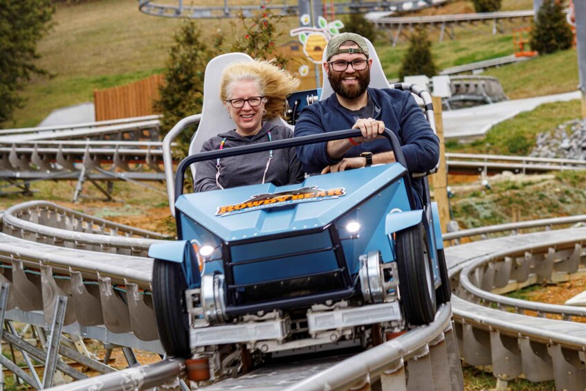 A blue roller coaster with two passengers. 3