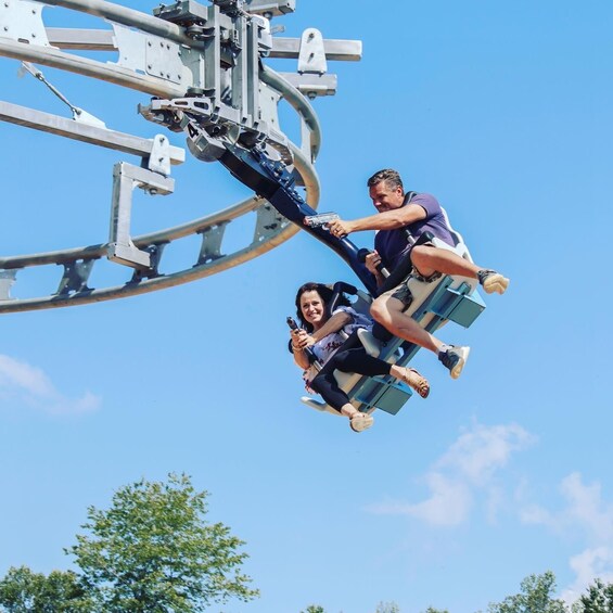 Two people on a swing ride at an amusement park. 1