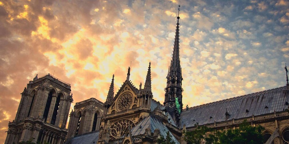 Notre-Dame Cathedral with its Gothic architecture and spires, under a dramatic sky. 5