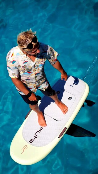 A person standing on a surfboard in a pool. 3