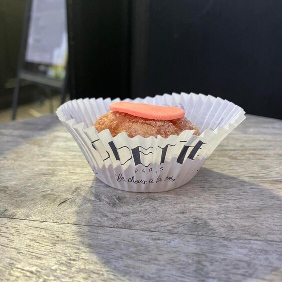 A cupcake in a paper cup with 'LE CHOUX A LA NIVE' text. 4