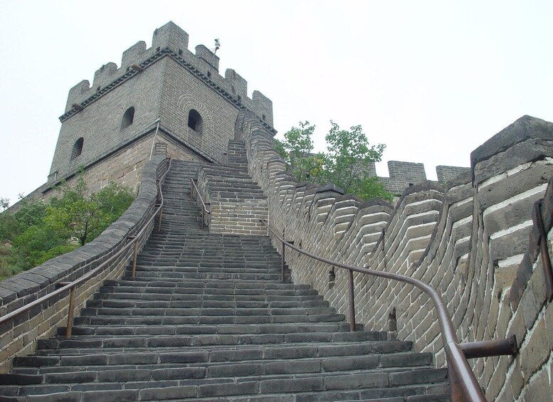 A stone staircase leading up to a large, fortress-like structure with crenellations. 2