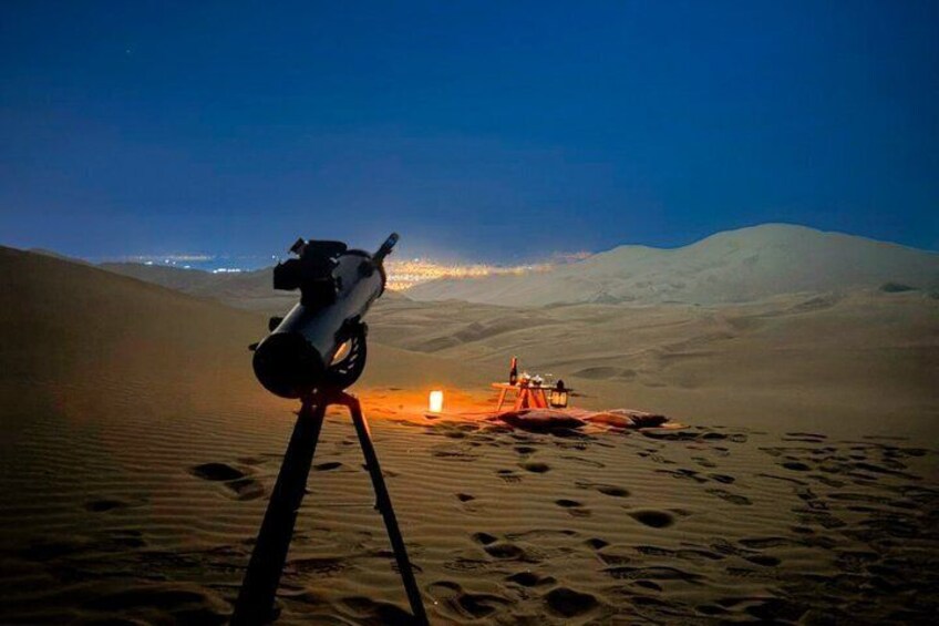 A telescope on a tripod in a desert with a vehicle in the background. 4