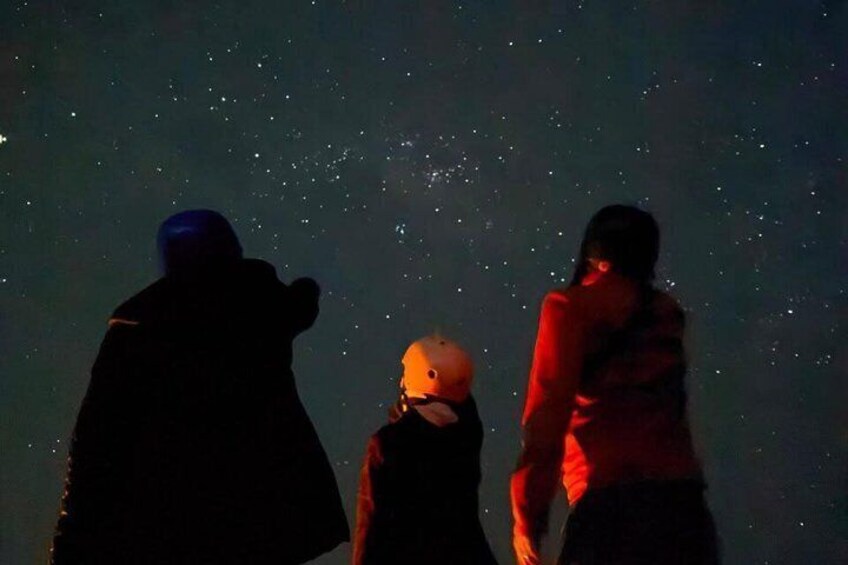 Three silhouetted figures against a starry night sky. 2