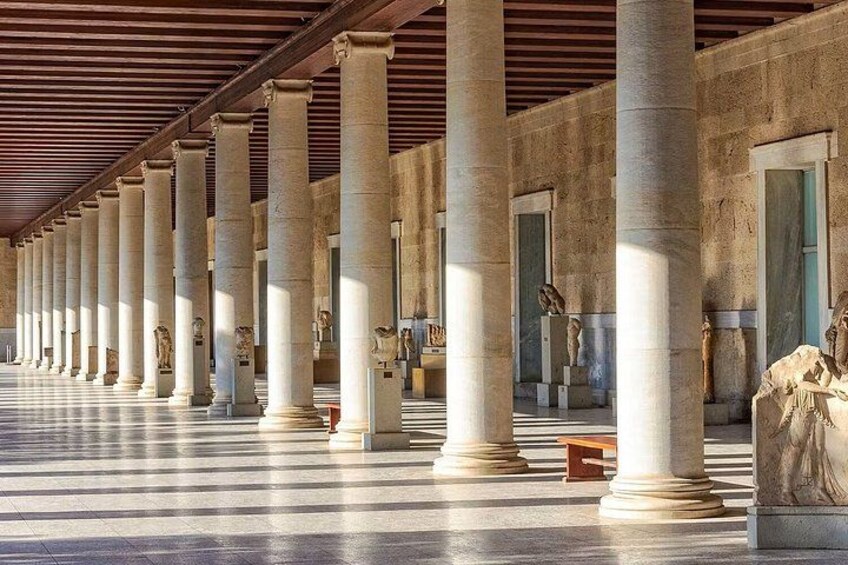 A colonnade with large columns and statues. 2