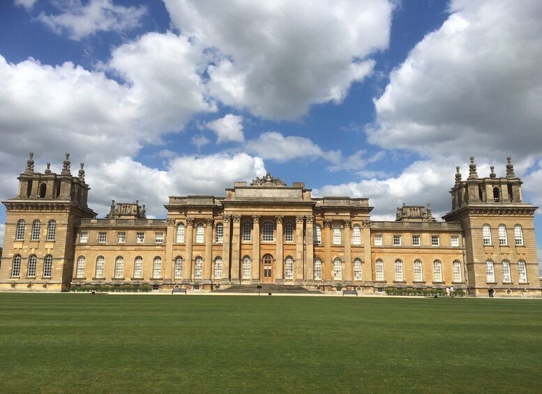 A large classical building with symmetrical architecture, a central entrance, and two towers on either side. 5