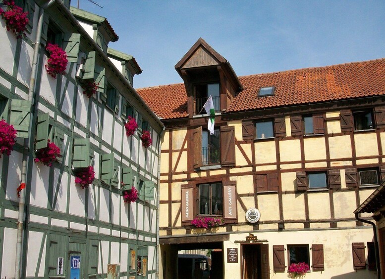 A traditional half-timbered building with a sign for 'Art Gallery.' 3