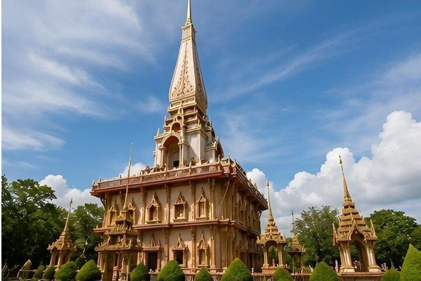 A temple with a tall spire, intricate architecture, and a clear blue sky. 5
