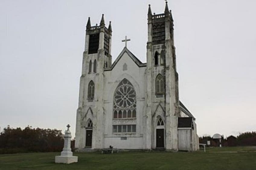 A large white church with two towers and a large arched window. 3
