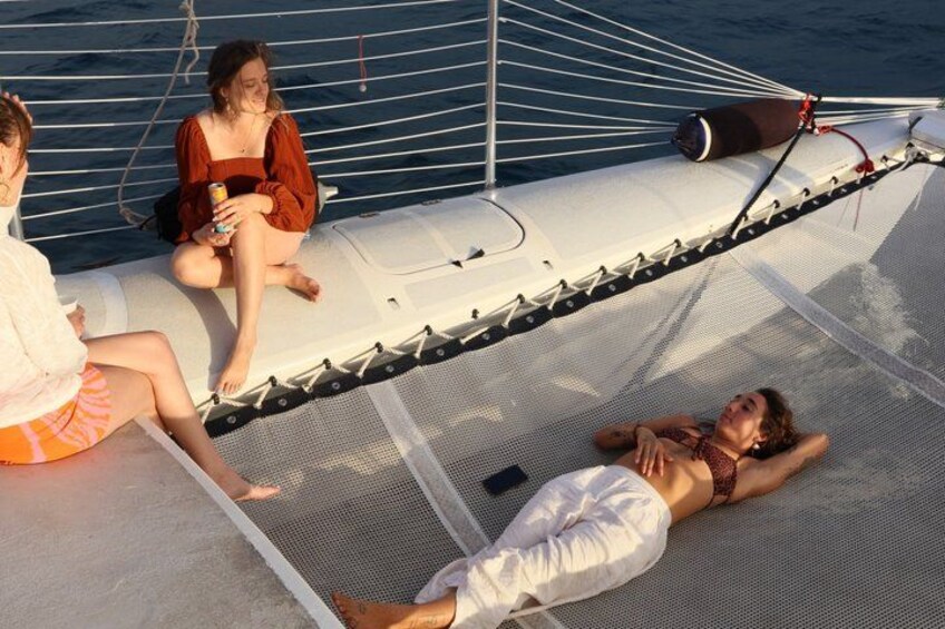 A sailboat with people relaxing on the deck. 3