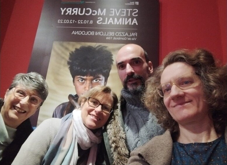 A group of people posing in front of a movie poster. 2