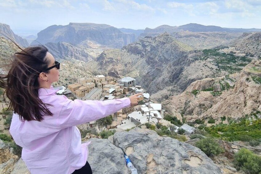 A person overlooking a village nestled in a mountainous valley. 5
