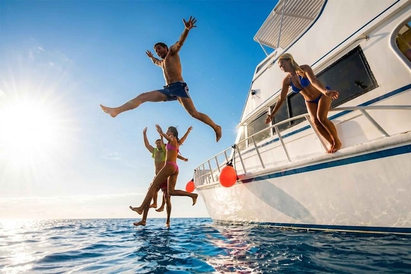 People jumping off a boat into the water. 1