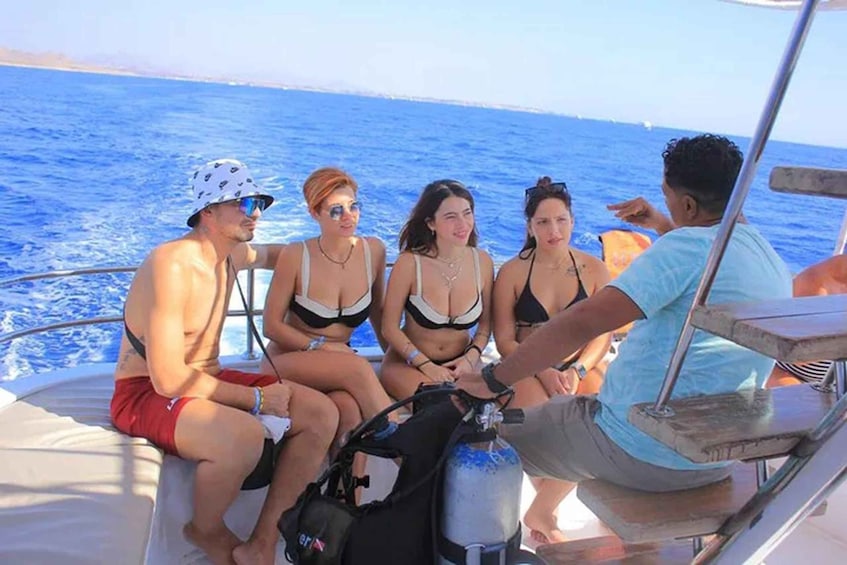 A group of people on a boat with the ocean in the background. 5